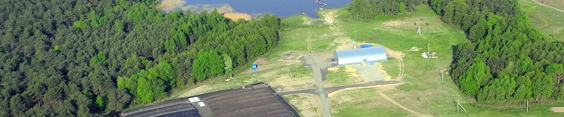 Aerial view of the shore facility at Lake Prybich, showing the store building, hardstanding and geotube dewatering beds